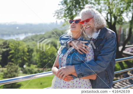 Joyful happy couple standing on the bridge 41642639