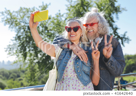 Happy nice couple showing V sign Happy nice couple showing V sign 41642640