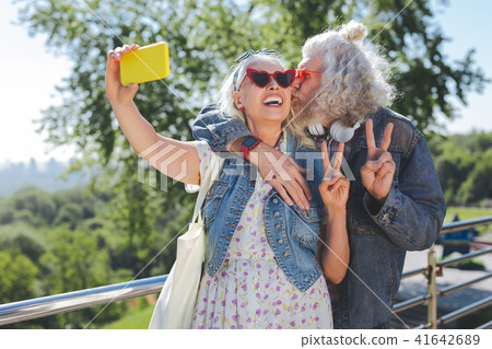 Joyful happy man kissing his wife Joyful happy man kissing his wife 41642689