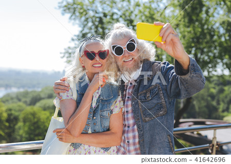 Delighted aged people wearing sunglasses Delighted aged people wearing sunglasses 41642696