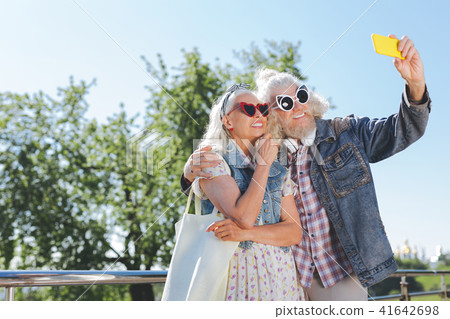 Nice cheerful couple looking into the camera Nice cheerful couple looking into the camera 41642698
