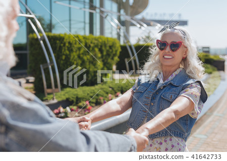 Nice cheerful woman holding her husbands hands Nice cheerful woman holding her husbands hands 41642733