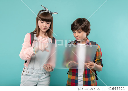 Alert schoolchildren holding a screen Alert schoolchildren holding a screen 41643621