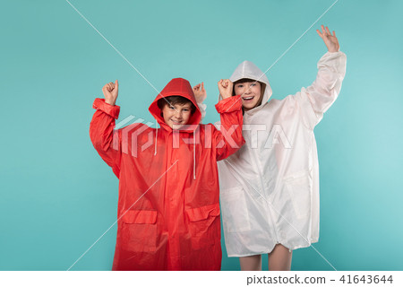 Merry kids wearing lovely raincoats Merry kids wearing lovely raincoats 41643644