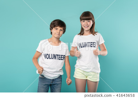 Alert young volunteers showing thumbs up 41643658