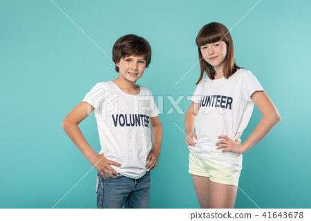 Content volunteers holding their hands on their waists Content volunteers holding their hands on their waists 41643678