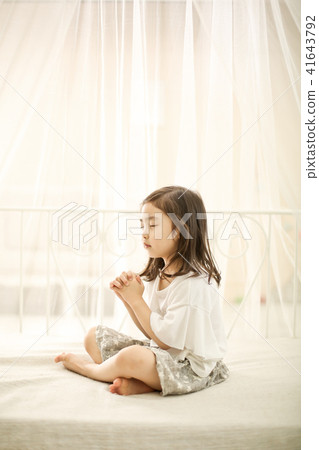 A girl praying A girl praying 41643792