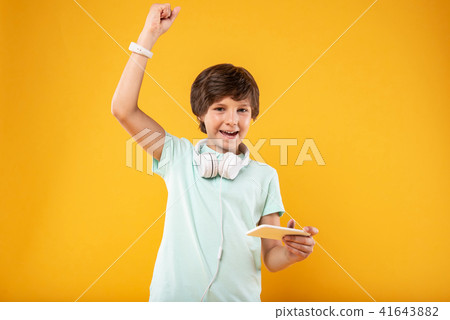 Exuberant boy using his modern phone 41643882