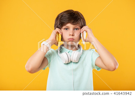 Funny schoolboy holding two phones 41643942