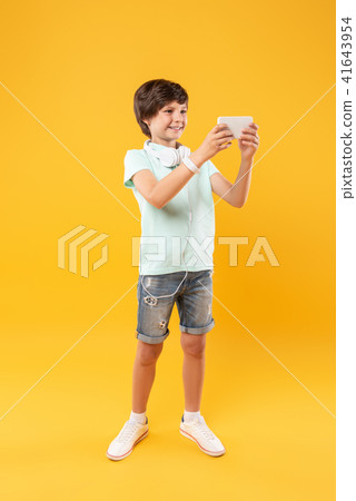 Gleeful boy taking selfies and having fun Gleeful boy taking selfies and having fun 41643954