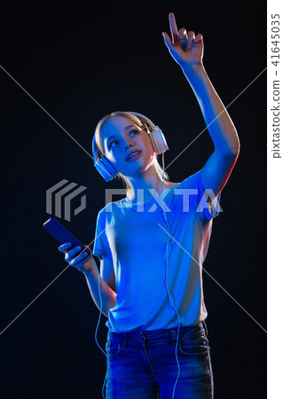 Delighted pleasant woman enjoying the music 41645035