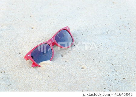 A red sun glasses at the beach,on the sand. 41645045