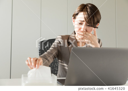 Woman blowing her nose 41645320