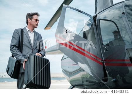 Businessman near private helicopter Businessman near private helicopter 41648281
