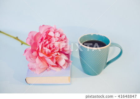 Peony flower and book on blue background 41648847