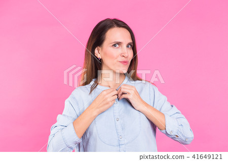 Smiling Woman in shirt posing in studio on pink background 41649121