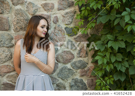 Beautiful girl with long hair standing the street Beautiful girl with long hair standing the street 41652428