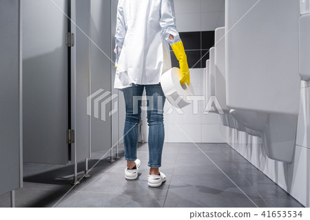 Janitor woman changing paper in public toilet 41653534