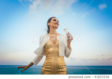 Woman sitting by the sea at a party on beach 41653556