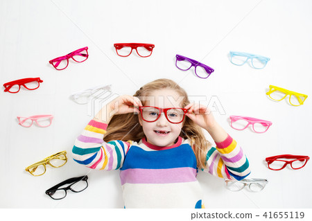 Child at eye sight test. Kid at optitian. Child at eye sight test. Kid at optitian. 41655119