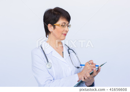 Medical doctor writing prescription over white background. Medical doctor writing prescription over white background. 41656608