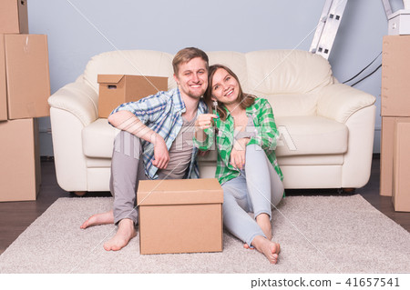 Happy love couple in her new home holding key Happy love couple in her new home holding key 41657541