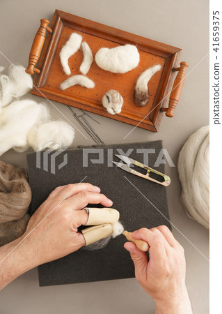 Needle felting a rabbit Needle felting a rabbit 41659375
