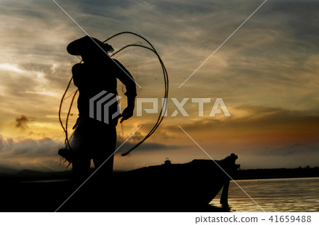 Fisherman in action when cleaning net on boat Fisherman in action when cleaning net on boat 41659488
