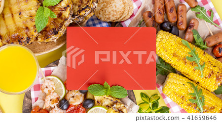 Different fruits and vegetables on grilled and shrimp. Yellow background. Summer dinner. Free space Different fruits and vegetables on grilled and shrimp. Yellow background. Summer dinner. Free space 41659646