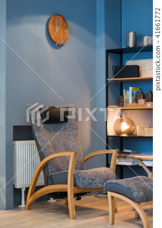 Apartment with modern armchairs and blue wall Apartment with modern armchairs and blue wall 41661772