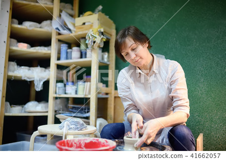 woman making clay object. The sculptor during work woman making clay object. The sculptor during work 41662057