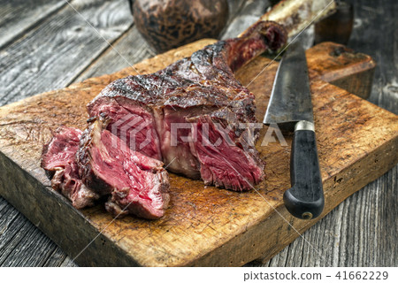Barbecue dry aged Wagyu Tomahawk Steak as close-up Barbecue dry aged Wagyu Tomahawk Steak as close-up 41662229