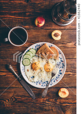 Breakfast toast with fried eggs with vegetables, fruits and coff Breakfast toast with fried eggs with vegetables, fruits and coff 41662440