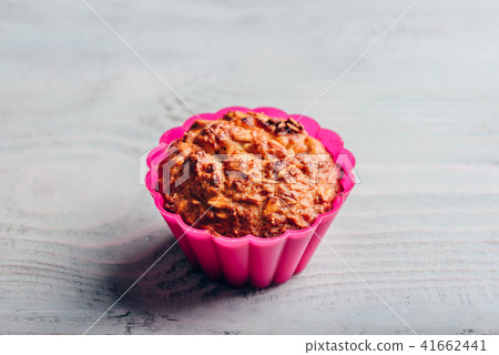Oatmeal muffin in pink bakeware. Oatmeal muffin in pink bakeware. 41662441