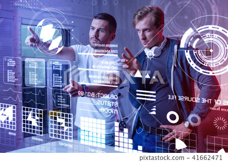 Careful programmer touching the screen and his colleague looking at it 41662471