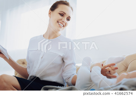 Cheerful female person playing with her baby 41662574