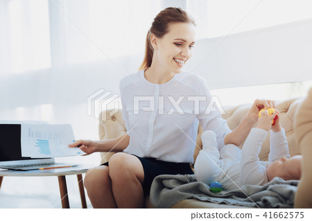 Joyful young mommy taking rubber duck Joyful young mommy taking rubber duck 41662575