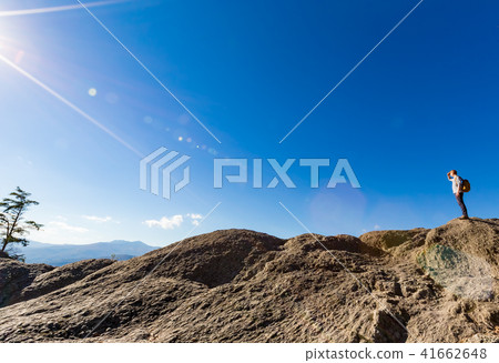 Man walking on the edge of a cliff Man walking on the edge of a cliff 41662648