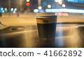 a cup of coffee is on the dashboard of the car 41662892