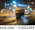 a cup of coffee is on the dashboard of the car 41662894