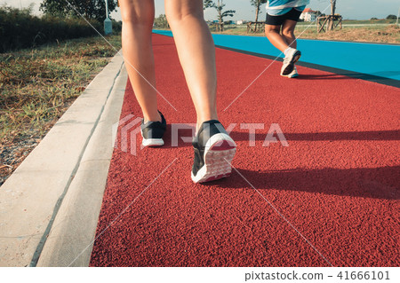 Close up portrait of sporty woman is running 41666101