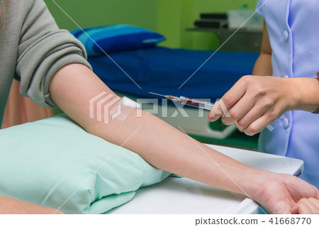 Nurse collecting a blood from patient in hospital 41668770