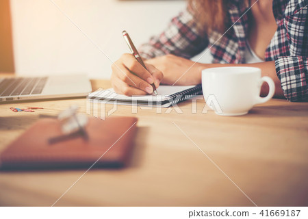 Young hipster woman writing and work in workplace. Young hipster woman writing and work in workplace. 41669187