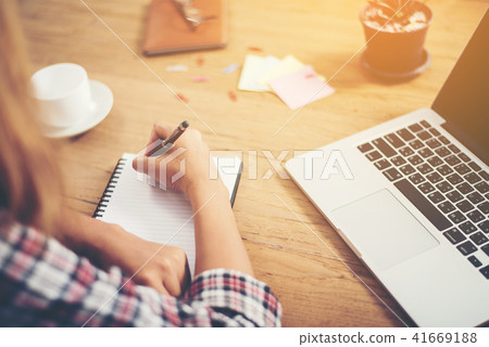 Young hipster woman writing and work in workplace. 41669188
