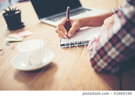 Woman hands writing plan work on note book. Woman hands writing plan work on note book. 41669190