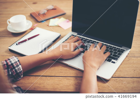 Close-up woman hands typing on laptop in office. Close-up woman hands typing on laptop in office. 41669194