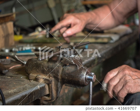 Close up on iron grip mounted on workbench at home Close up on iron grip mounted on workbench at home 41669707
