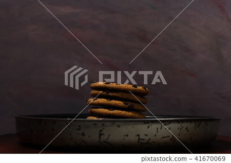Cookies with chocolate crumbs on a dish table. Cookies with chocolate crumbs on a dish table. 41670069