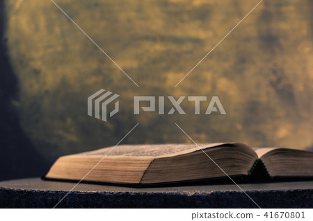 Holy Bible on a stone round table Gold background 41670801