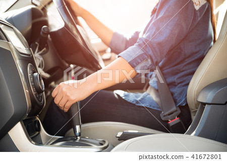 woman driver hand shifting the gear stick 41672801